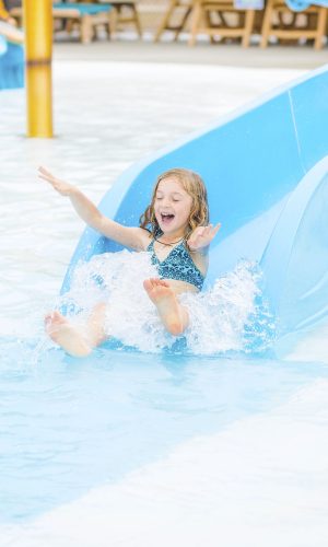 young girl on kid slide